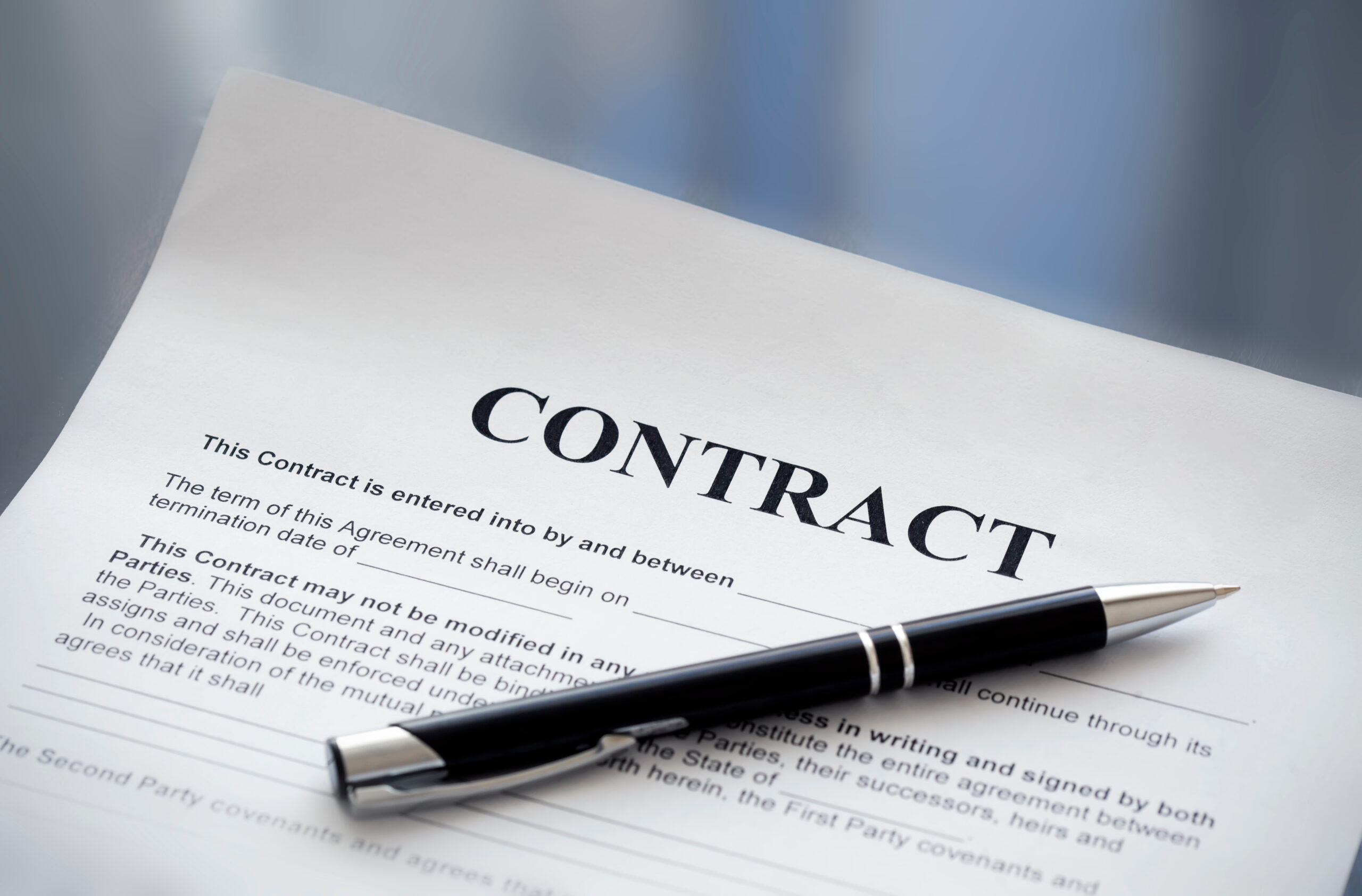 Andy Contiguglia sits at a desk getting ready to complete a business deal.