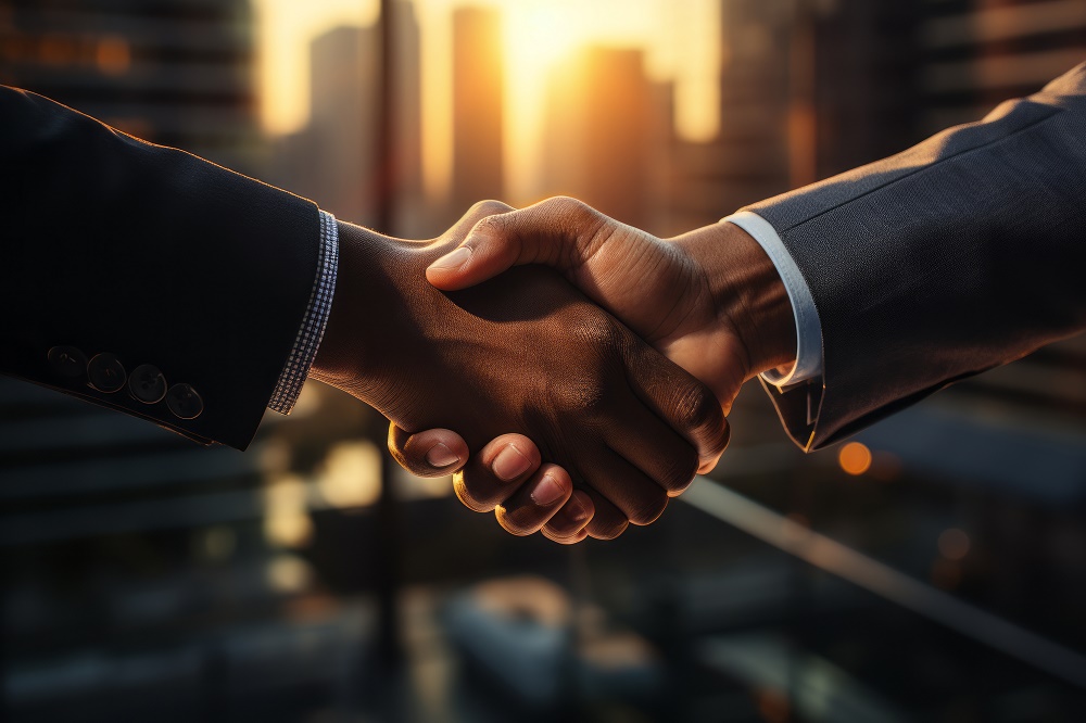 Two businessmen shaking hands, agreeing to a contract.