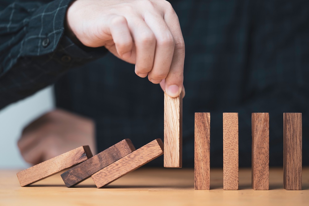 Domino effect representing proactive risk management practices